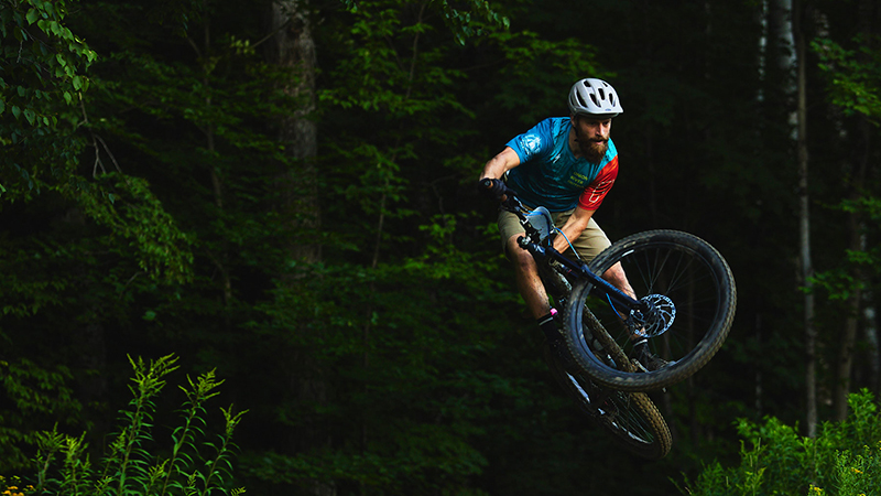 Man jumps on a mountain bike during a race